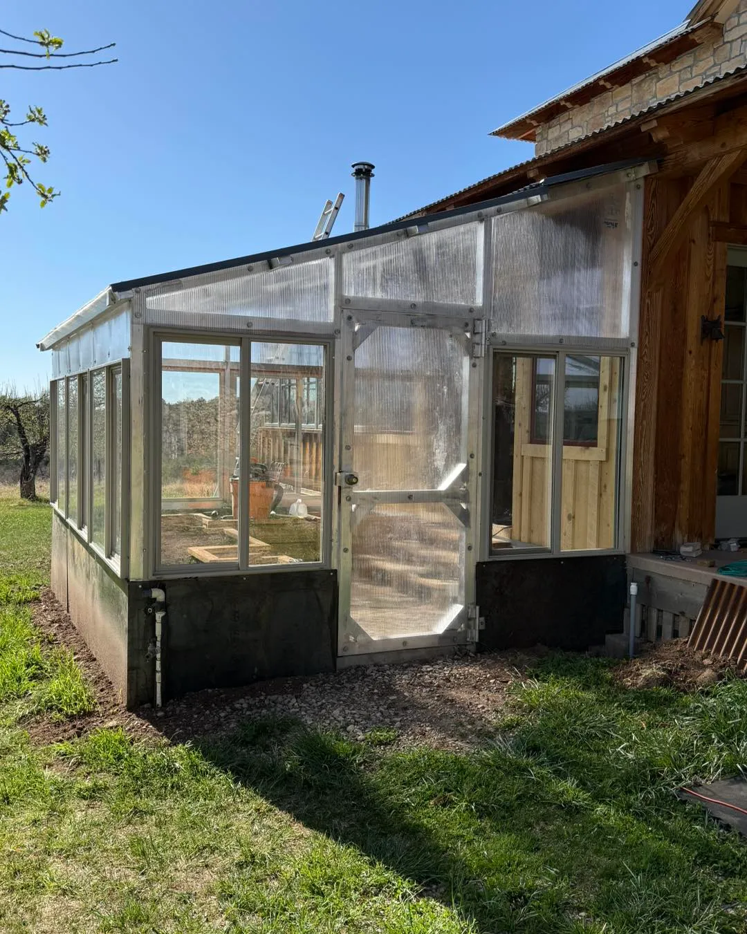 Greenhouse structure showing detailed door and ventilation system installation