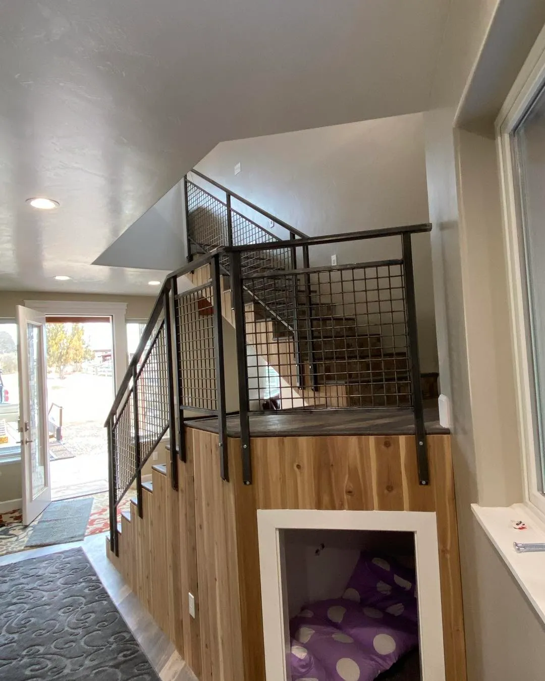 Modern interior staircase with contemporary metal mesh railing design