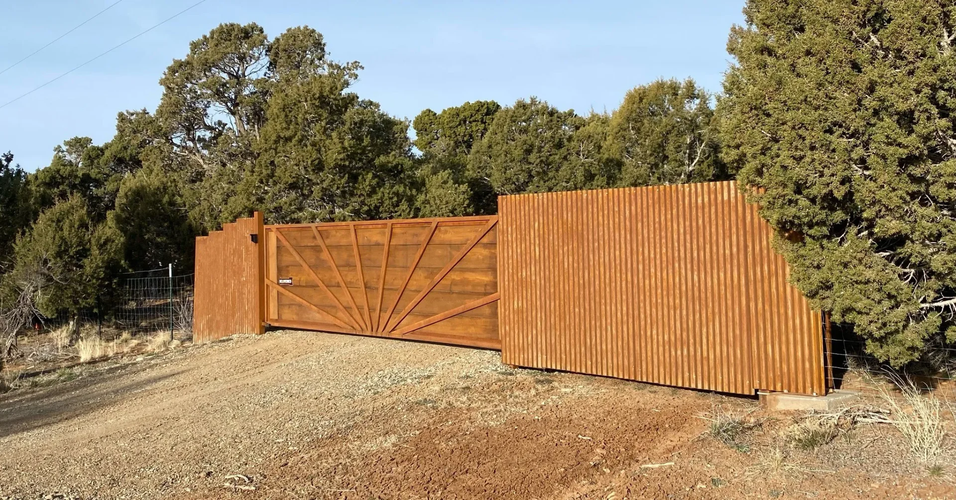 Premium wooden fence with decorative metal gate featuring sunburst design